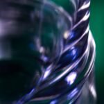 a close up of a glass with a blurry background